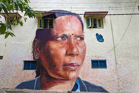 Mural titled 'Pourakarmika' by Param in Malleshwaram, Bengaluru