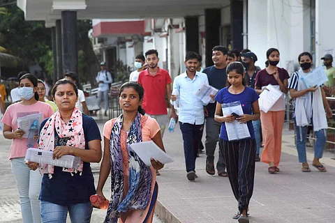 Students walking with paper in hand