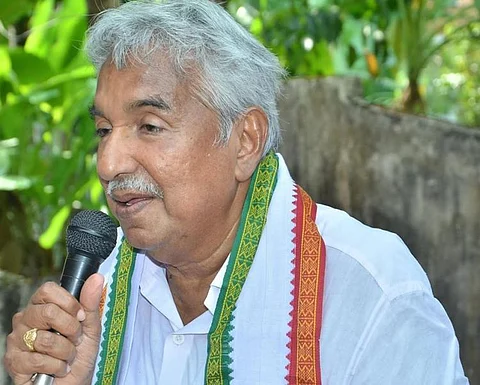 Former Kerala CM Oomen Chandy of the UDF holding a mike