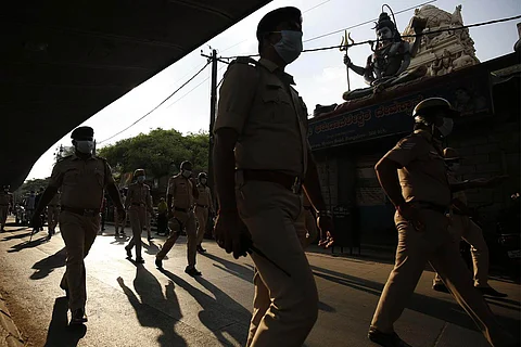 Policemen walking under the bridge of a public road