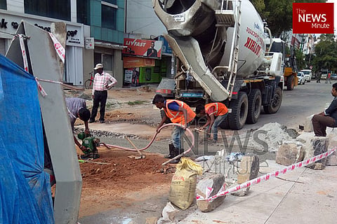 Workers filling potholes in Bengaluru