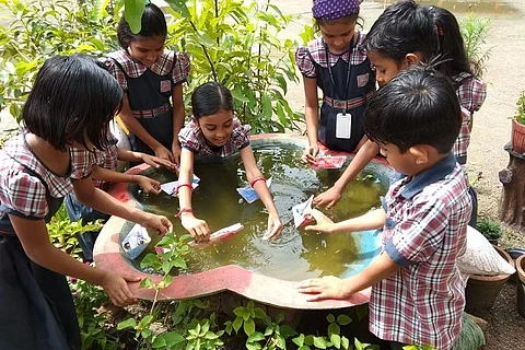 School children playing with water