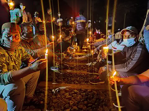 Save Mollem protestors sitting on candle light vigil at railway track
