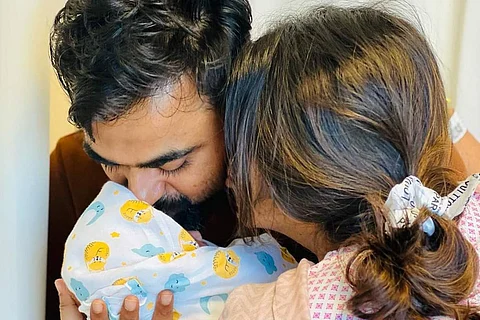 Shamna and her husband with their newborn