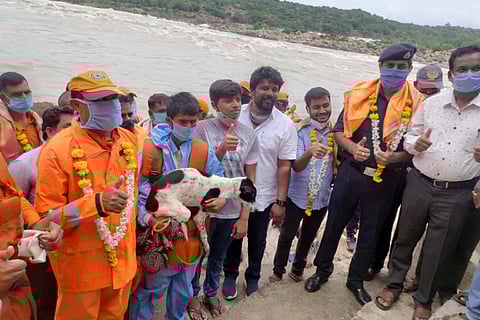 Shepherd with dog and their rescuers