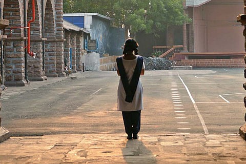 Student standing in a corridor at a school