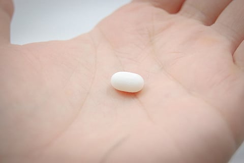 A person having a pill in his hand