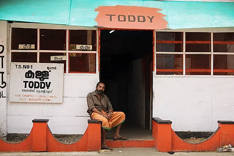 Man in front of toddy shop in Kerala