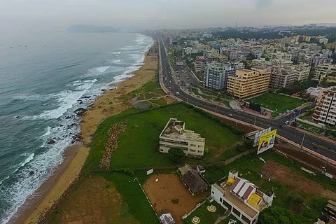 Aerial view of RK beach in Vizag with buildings on the right side of the beach road