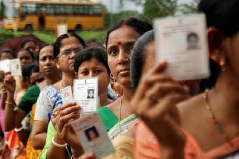 Voters showing their voter IDs
