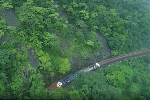 An aerial view of a train passing through thick forests of Western Ghats in Karnataka