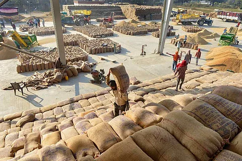 Representative image of workers at a grain market
