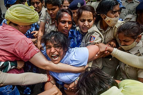 Wrestlers being manhandled