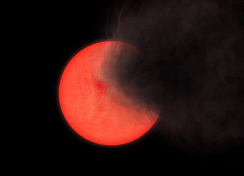 This handout image released by the University of Hertfordshire on January 26, 2024, shows an artists' impression of a cloud of smoke and dust being thrown out by a red giant star. Seen from the left the star remains bright but if viewed from the right it fades to invisibility, which represents some at the center of our Milky Way galaxy, that faded away and then reappeared over the course of several years.