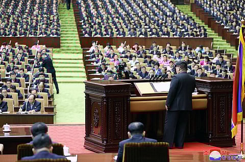 This picture taken on January 15, 2024 and released from North Korea's official Korean Central News Agency (KCNA) via KNS on January 16, 2024 shows North Korea's leader Kim Jong Un (R) speaking at the 10th session of the 14th Supreme People's Assembly (National Assembly) at the Mansudae Assembly Hall in Pyongyang. (Photo by KCNA VIA KNS / AFP)