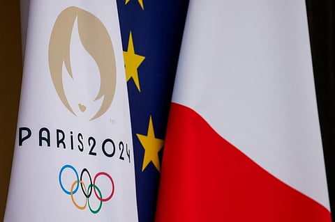 This photograph shows the Paris 2024 Olympics Games flag next to European Union and French flag at the presidential Elysee Palace in Paris, on 12 January 2024.
