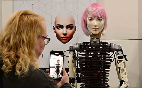 Unreal A woman photographs a humanoid robot from AI Life with Bio-Inspired communicative AI that went on display at the recent Consumer Electronics Show in Las Vegas, Nevada. | FREDERIC BROWN/AGENCE FRANCE-PRESSE