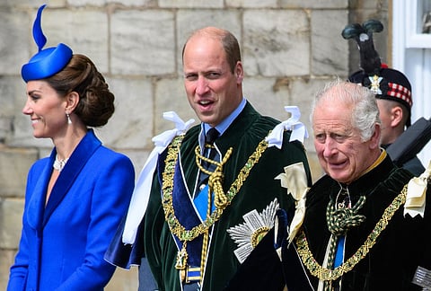 Britain’s King Charles III (R) stands with Britain’s Prince William, Prince of Wales and Britain’s Catherine, Princess of Wales to watch The British Royal Air Force’s (RAF) aerobatic team, the “Red Arrows”, perform a fly-past over the Palace of Holyroodhouse in Edinburgh on 5 July 2023, following a National Service of Thanksgiving and Dedication.
