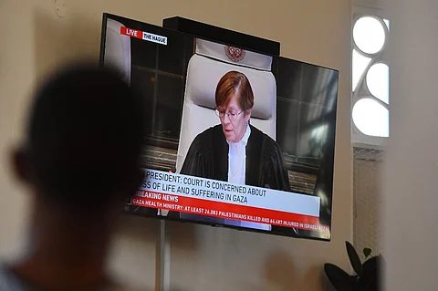 People gather to watch the International Court of Justice (ICJ) ruling of the case against Israel brought by South Africa in The Hague at the Bertha House in Cape Town on January 26, 2024. South African lawyers presented their case at the UN's top court in The Hague, where South Africa lodged an urgent appeal to force Israel to "immediately suspend" its military operations in Gaza. The International Court of Justice (ICJ) ruled on January 26, 2024 that it has jurisdiction over the genocide case.