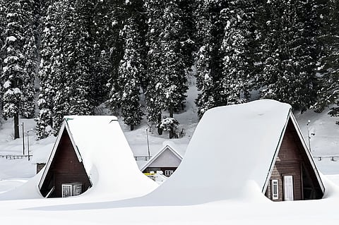 (FILES) Snow covered huts are pictured during the opening ceremony of Khelo India Winter Games at a ski resort in Gulmarg north of Srinagar on 10 February 2023. Winter in the Himalayas should mean blanketing snow and for Gulmarg in Indian-administered Kashmir, one of the highest ski resorts in the world, that usually means thousands of tourists. This year, the deep powder once taken for granted is gone. The slopes are brown and bare, a stark example of the impacts of the extreme weather caused by the rapidly heating planet, experts say.