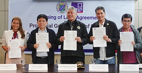 (L-R) DBP Senior Manager Sara Jane Nacion, DBP Senior Vice President Daniel Gonzales, Palawan Governor Dennis Socrates, Vice Governor Leoncio Ola, and Provincial Treasurer Elino Mondragon hold the approved loan agreement for ₱2 billion to enhance the province's infrastructure projects for climate change resilience.
