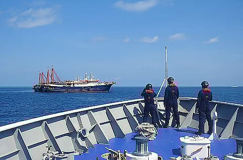 (FILED PHOTO) Philippine Coast Guard crew members aboard the BRP Cabra monitor a Chinese vessel anchored at Sabina Shoal, a West Philippine Sea outcrop located about 135 kilometers west of Palawan. China’s ‘aggressive’ actions in the WPS have earned condemnation from the Philippines and such countries as the United States, Japan and Australia.
