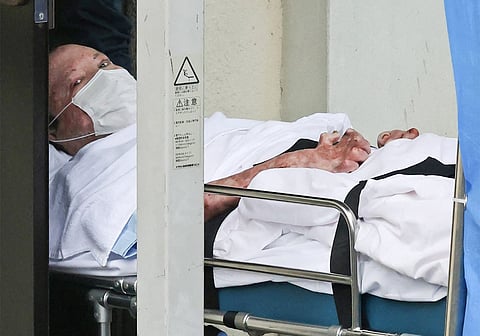 (FILES) Shinji Aoba, who is suspected of the Kyoto Animation studio arson attack, looks up as he is transported on a stretcher to the Fushimi police station in Kyoto on 27 May 2020.