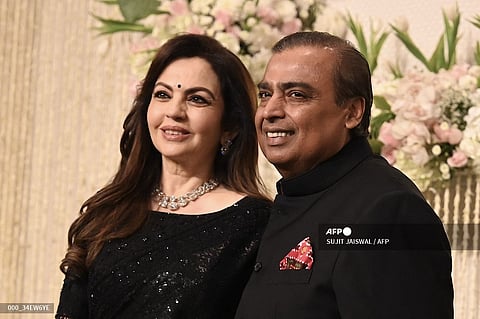 Chairman and Managing Director of Reliance Industries, Indian billionaire businessman Mukesh Ambani with his wife and Founder Chairperson of the Reliance Foundation Nita Ambani poses for a photograph during the wedding reception ceremony of actor Amir Khan's daughter, Ira Khan, in Mumbai on 13 January 2024.