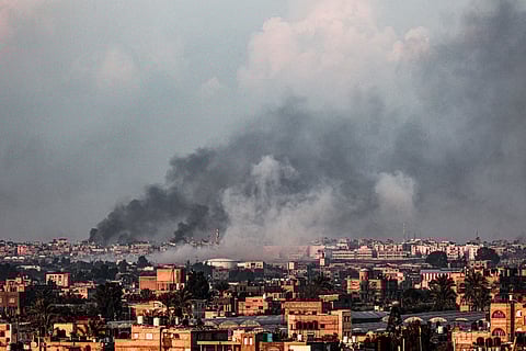 A picture taken from Rafah shows smoke billowing over Khan Yunis in the southern Gaza Strip during Israeli bombardment on February 18, 2024, amid continuing battles between Israel and the Palestinian militant group Hamas.