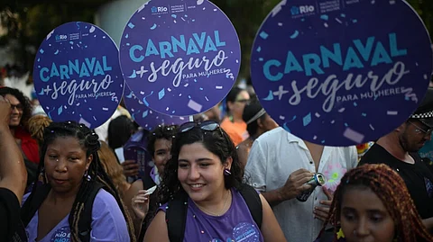 Rio government workers promote safety for women at a carnival street party on February 8, 2024