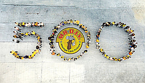 MR.DIY Philippines employees commemorate their 500th milestone with a remarkable human formation depicting the number 500.