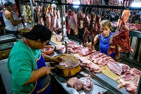 (FILE) A senior citizen buys meat in a wet market in Sta. Ana, Manila on Tuesday, despite its still high price, amid the report of the Philippine Statistics Authority stating that the inflation rate in January 2024 eased further to 2.8 percent, well within the government’s target range of 2 to 4 percent.