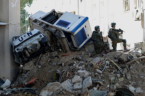 Israeli soldiers inside an evacuated compound of the United Nations Relief and Works Agency for Palestine Refugees (UNRWA) in Gaza City, amid ongoing fighting between Israel and the Palestinian militant group Hamas.
