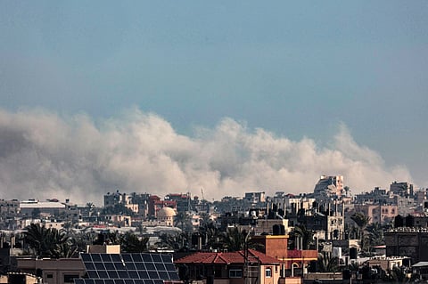 This picture taken from Rafah shows smoke billowing following Israeli bombardments over Khan Yunis in the southern Gaza Strip on February 13, 2024, amid the ongoing conflict between Israel and the Palestinian Hamas militant group.