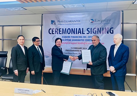 At the signing ceremony are (from left) Philguarantee chief legal counsel Isabelo Gumaru, SVP Celso R. Gutierrez-priority sector guarantee group, president Alberto E. Pascual; and Esquire Financing chairperson and CEO Rajan Uttamchandani and president and COO Navin Uttamchandani.