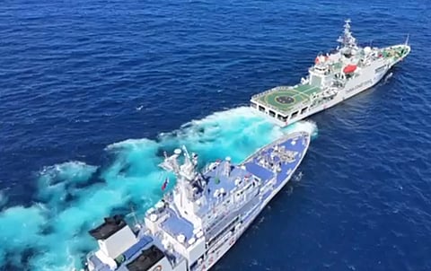 (FILE) This frame grab from handout video taken on 8 February 2024 and released by the Philippine Coast guard (PCG) on 11 February shows a Chinese coast guard vessel (front R) blocking and sailing past Philippine coast guard ship BRP Teresa Magbanua (back L) near Scarborough Shoal, in the disputed South China Sea. The Philippine Coast Guard on February 11 accused Chinese vessels of "dangerous" maneuvers during a nine-day patrol near a reef off the coast of the Southeast Asian country.