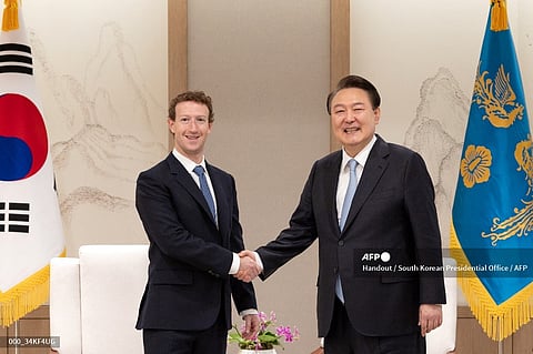 This handout photo taken on 29 February 2024 and released by the South Korean Presidential Office via Yonhap shows South Korean President Yoon Suk Yeol (R) shaking hands with Mark Zuckerberg (L), head of US tech giant Meta, during their meeting at Yoon's office in Seoul.
(Handout / South Korean Presidential Office / AFP)