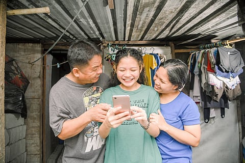 Jane Sison, an SM Scholar, and her family celebrate as she receives acceptance into the SM College Scholarship program.