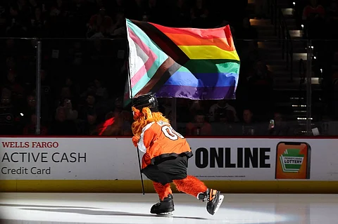Philadelphia Flyers mascot, Gritty, skates with a pride flag before a game between the Philadelphia Flyers and the Montreal Canadiens at the Wells Fargo Center on 10 January 2024 in Philadelphia, Pennsylvania.