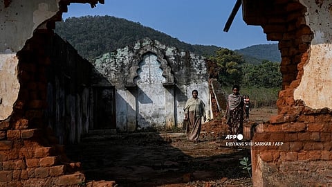 In this photograph taken on 28 February 2024, Christian villagers walk inside a church, destroyed by a mob 16 years ago after the murder of a Hindu priest, in Irpiguda village of Kandhamal district in India's Odisha state.