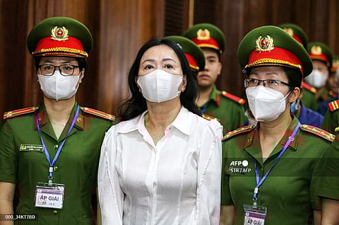 Vietnam's property tycoon Truong My Lan (C) arrives at a court in Ho Chi Minh city on March 5, 2024. A top Vietnamese property tycoon went on trial on March 5, 2024 along with dozens of others, accused of embezzling $12.5 billion in the country's biggest ever fraud case.