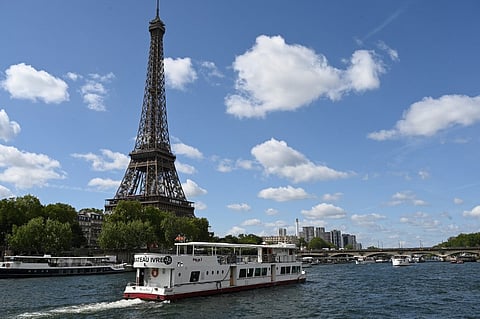 A Peniche boat sails past the Eiffel Tower on the River Seine on July 17, 2023, during a parade to test "maneuvers", "distances", "duration" and "video capture" of the future opening ceremony of the Paris Olympics in 2024. A total of 326,000 tickets are set to be sold or given away for free for the opening ceremony of the Paris Olympics on the river Seine, Interior Minister said on March 5, 2024, giving the exact number for the first time.