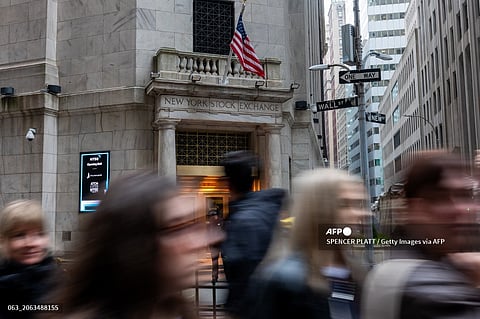 People walk by the New York Stock Exchange (NYSE) on March 06, 2024 in New York City.