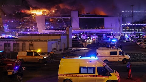 Emergency services vehicles are seen outside the burning Crocus City Hall concert hall following the shooting incident in Krasnogorsk, outside Moscow, on March 22, 2024.