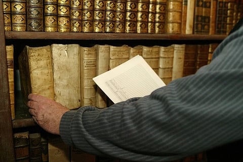 (FILES) Director of the Calvinistic College Library in Sarospatak, Denes Dienes shows the empty spaces left by books missing in the library on 08 February 2006 in Sarospatak 230km east from Budapest. 138 books from the 14th and 15th century will arrive back to the library, after Russian lawmakers voted Friday to give back to Hungary a valuable book collection confiscated by Soviet troops during World War II and kept in Russia as compensation for wartime losses.