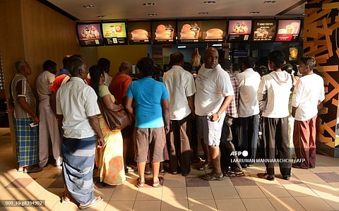 (FILES) Customers line up at a McDonald's store as they give away 1,000 burgers free to mark national Breakfast Day in the capital Colombo on 18 March 2013.