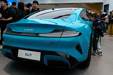 A Xiaomi SU7 electric car is displayed at a Xiaomi store in Beijing on 26 March 2024.