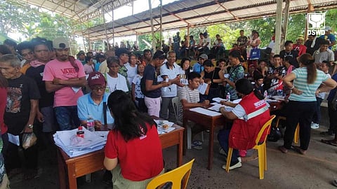 Disaster-hit families from the municipality of Tarragona in Davao Oriental wait for their turn to receive their emergency cash transfer (ECT) from personnel of the Department of Social Welfare and Development (DSWD) Field Office-11 (Davao Region) during a payout on Monday, 4 March 2024.