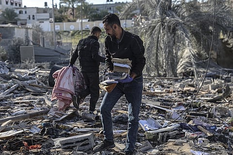 Palestinians search for their belongings amid the rubble of houses destroyed by Israeli bombardment in Rafah in the southern Gaza Strip on March 11, 2024, amid continuing battles between Israel and the Palestinian militant group Hamas.