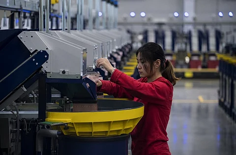(FILES) This picture taken on November 24, 2016, shows a worker checking the production in the packaging section of the newly opened Lego factory in Jiaxing. Lego's first Asian factory opened in China, the company said, a year after the Danish firm found itself embroiled in controversy over refusing to sell toy bricks to provocative Chinese artist Ai Weiwei. Only the fifth Lego factory in the world, the plant in eastern Zhejiang province will pump out up to 80 percent of the company's products sold in the booming Asia market, the company said.